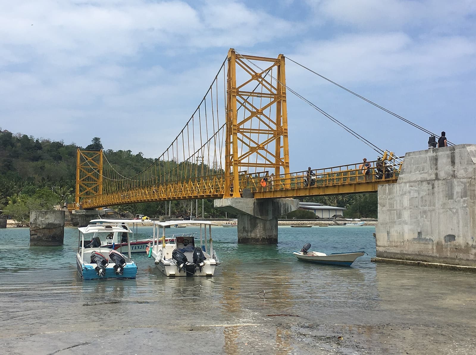 The yellow suspension bridge over the channel between Nusa Lembongan and Nusa Ceningan