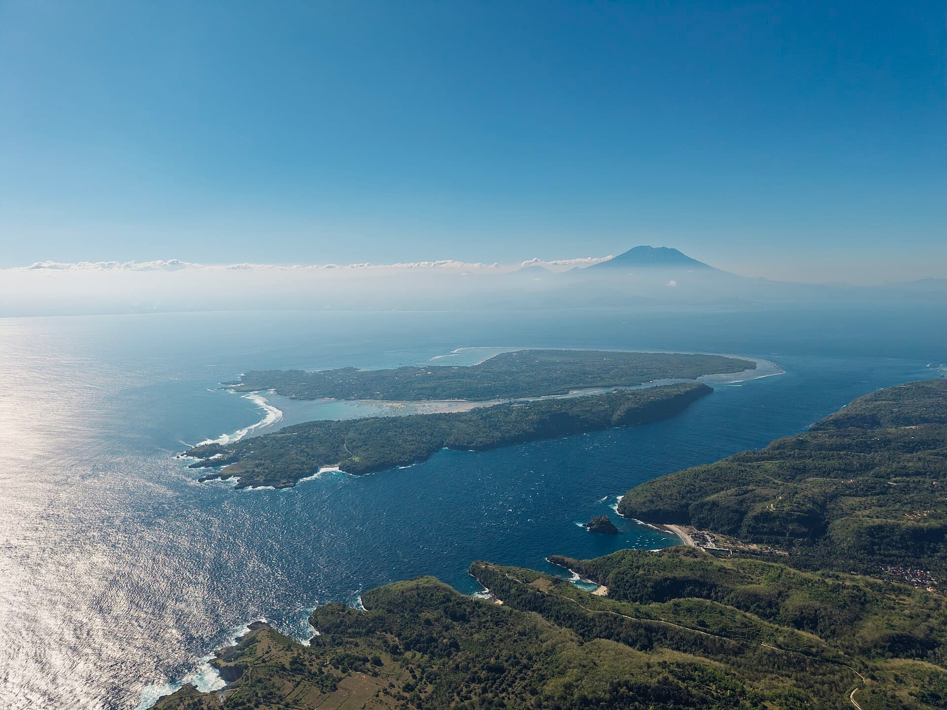 Aerial view of Nusa Ceningan and Nusa Lembongan with Mount Agung on Bali behind