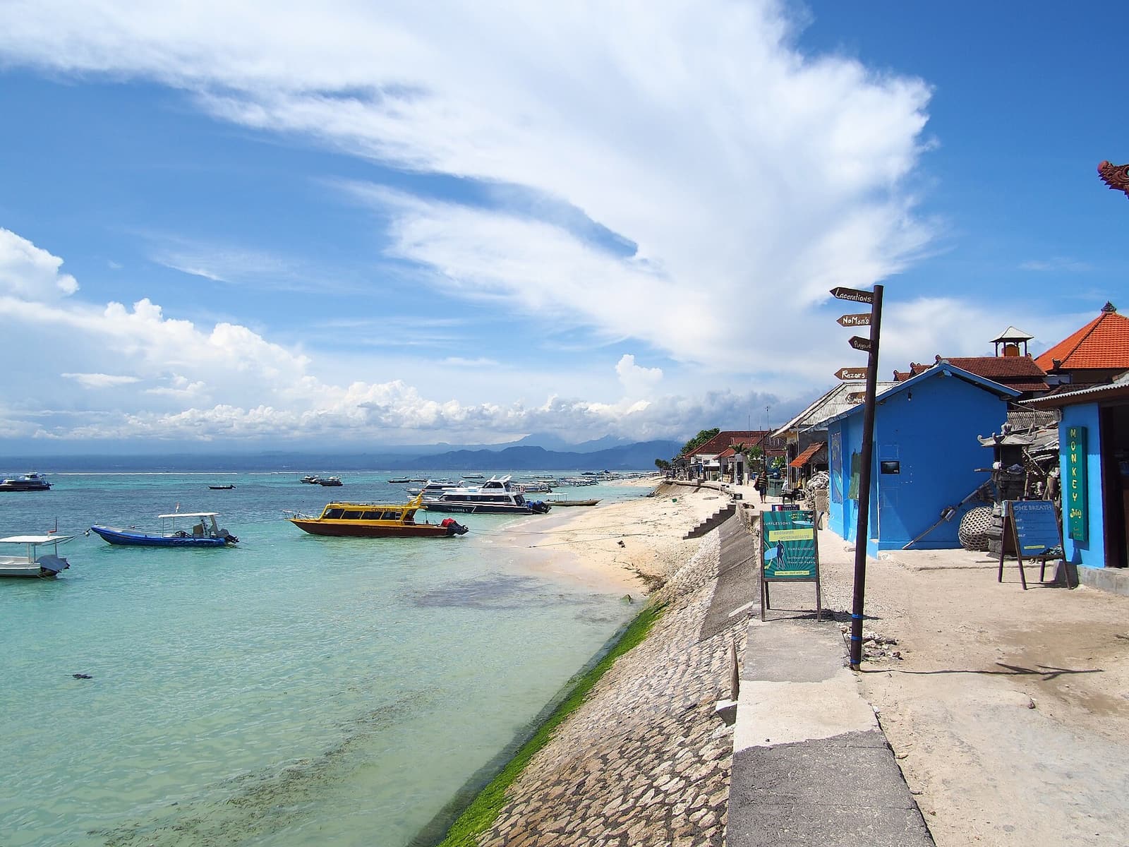 Moored boats and a seafront path on the main beach at Jungutbatu, Nusa Lembongan